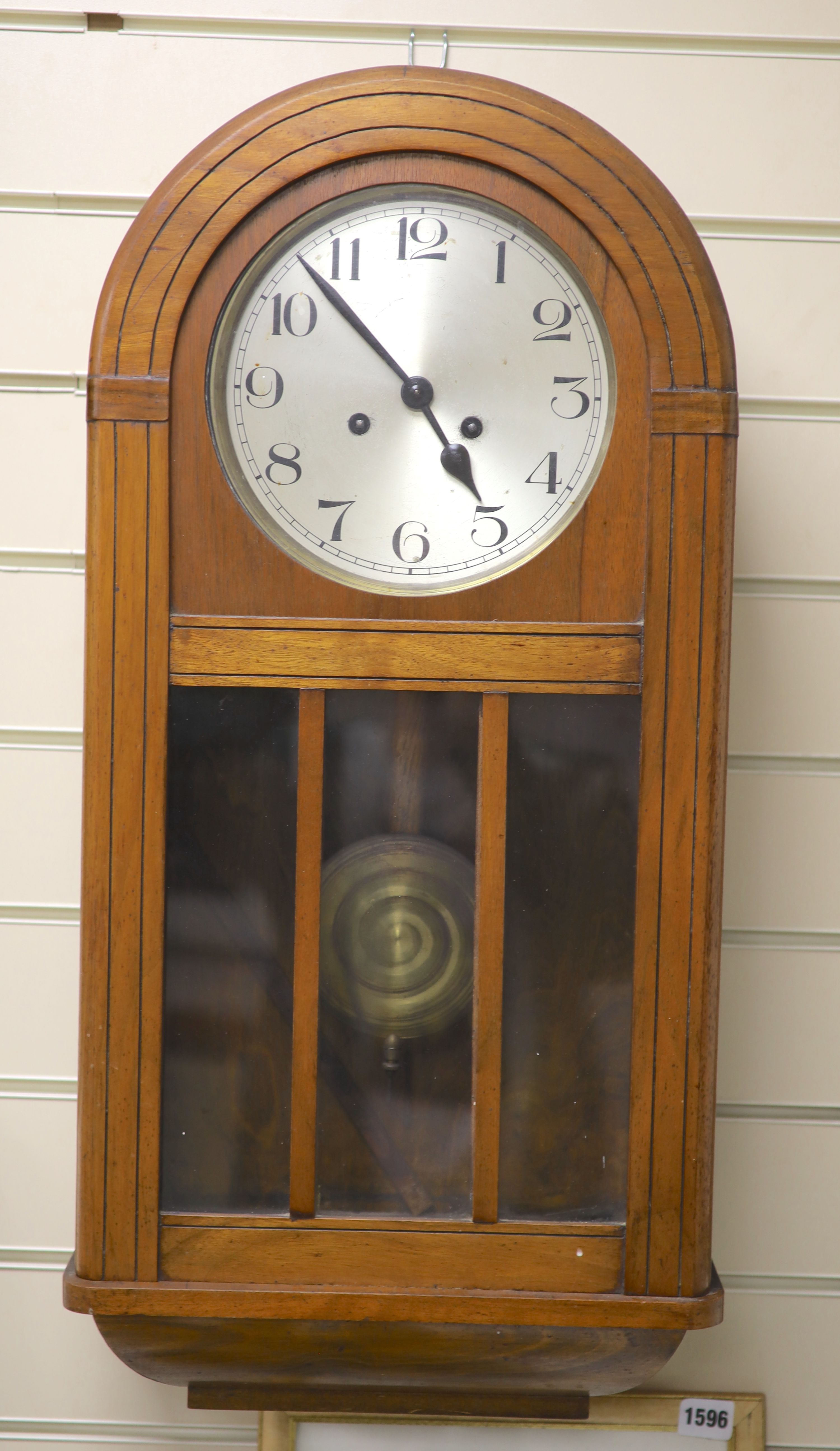 A 1920s walnut wall clock